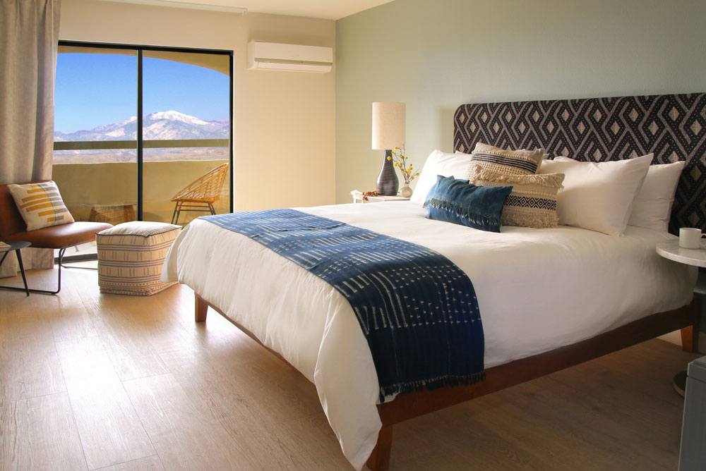 Western views of city lights framed by snow-capped Mt. San Gorgonio from a private balcony
