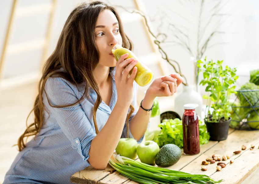 Woman drinking green juice