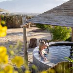 Woman soaking in Oasis tub at Azure Palm Hot Springs